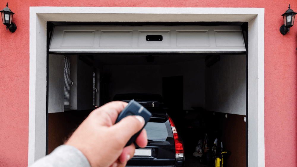 man-using-remote-to-open-garage-door